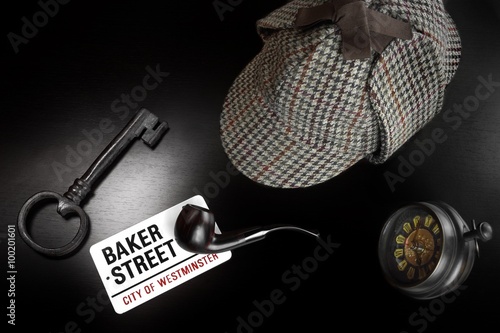 Baker Street Sign And Sherlock Holmes Items On Black Table photo