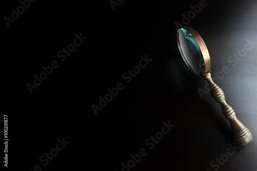 Vintage Magnifying Glass On The Black Table