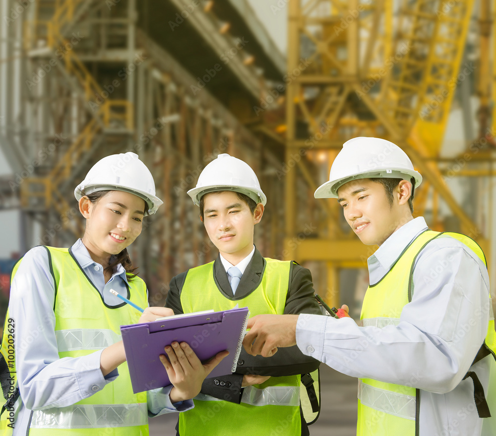 Fototapeta premium Asian working discussing checklist with foreman in port