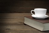 Empty Tea Cup On The Red Old Book In Dark