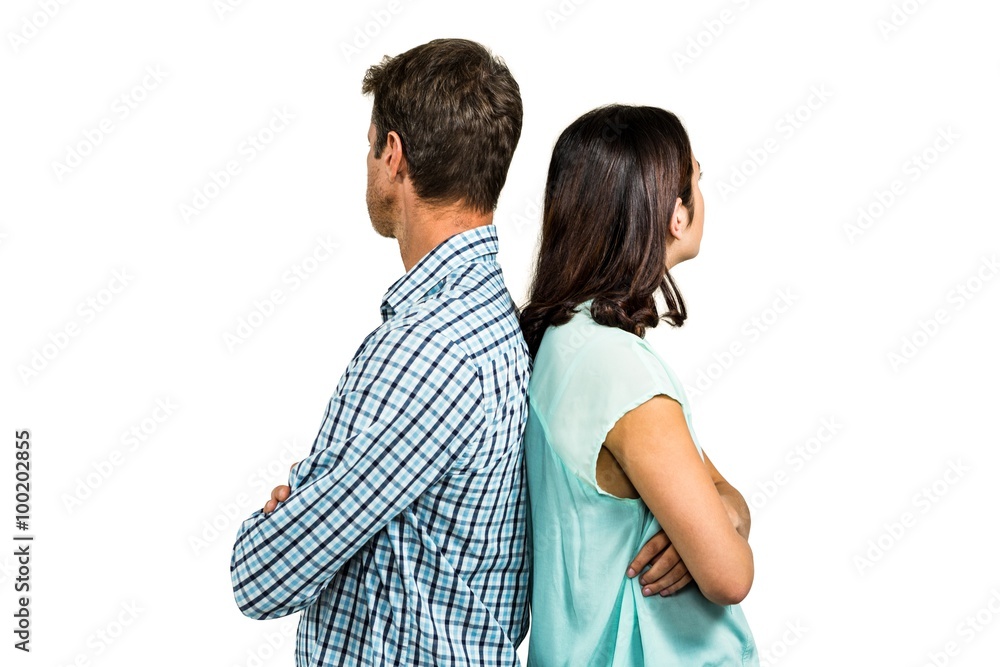 Couple ignoring each other while standing back to back Couple ignoring each other while standing back to back