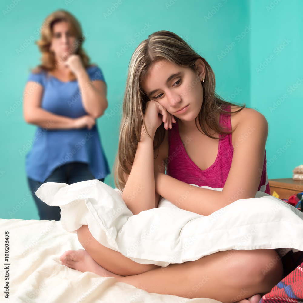 Sad teen girl and her worried mother Sad teen girl and her worried mother