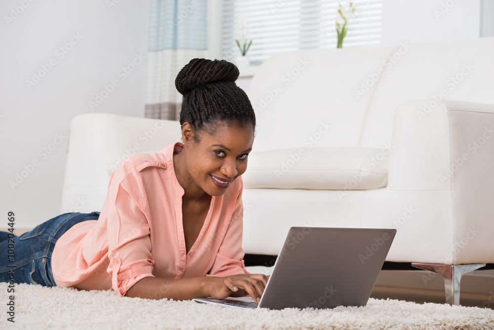 Woman Using Laptop On Carpet Woman Using Laptop On Carpet