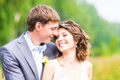 young wedding couple, beautiful bride with groom portrait, summer nature outdoor © satura_