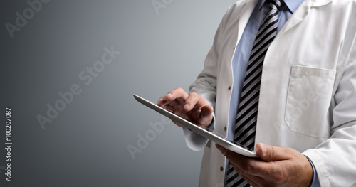 Fotografie Doctor using digital tablet
