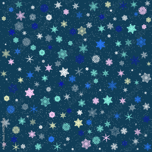 Pattern of colored patterned snowflakes on a blue background