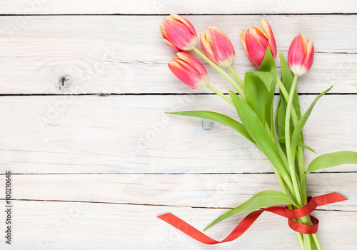 Colorful tulips on wooden table