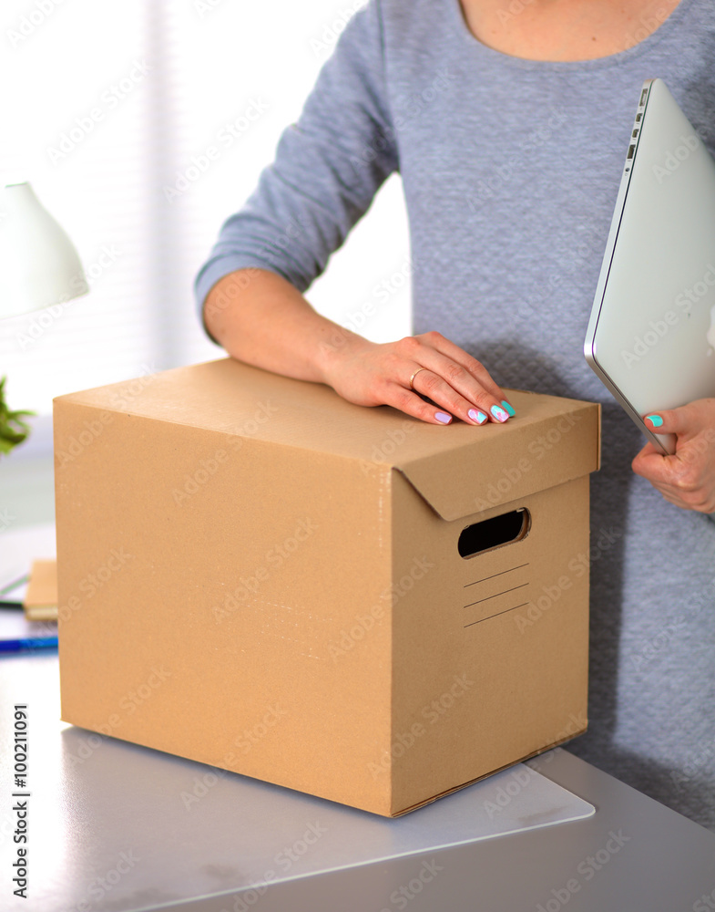 Happy team of businesspeople moving office, packing boxes, smiling Happy team of businesspeople moving office, packing boxes, smiling