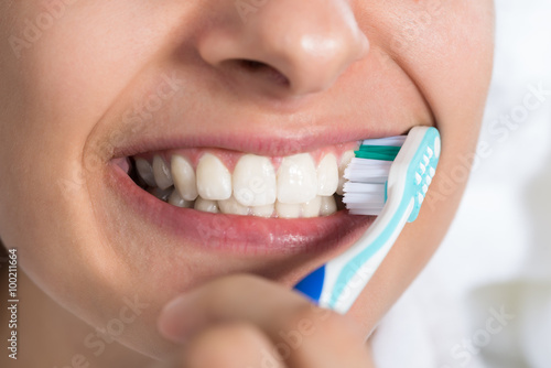 Woman Brushing Teeth At Home