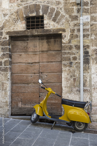 Gubbio (Italy) - Famous Italian scooter parked in a street of the ancient town of Gubbio in Umbria