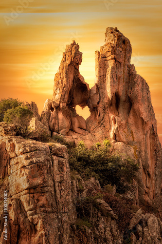 Heart-shaped hole in rock in The Calanches in Corsica at sunset