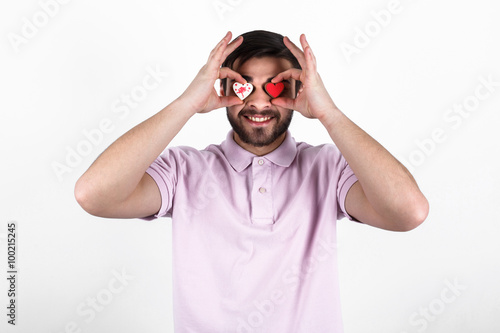 valentine romantic man holding candy hearts and smilling