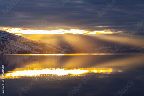 Rays of Sunset on Mountain Lake in Winter