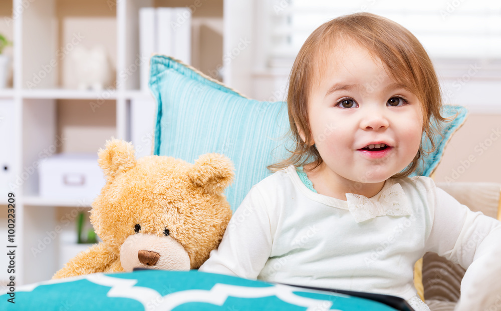 Happy toddler girl with her teddy bear and tablet pc Happy toddler girl with her teddy bear and tablet pc