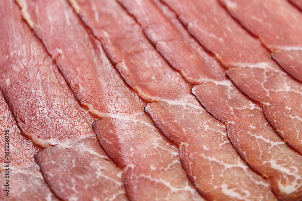 Slices of prosciutto ham. Background. Shallow depth of field.