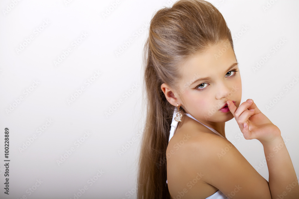 Little girl has put forefinger to lips as sign of silence Little girl has put forefinger to lips as sign of silence