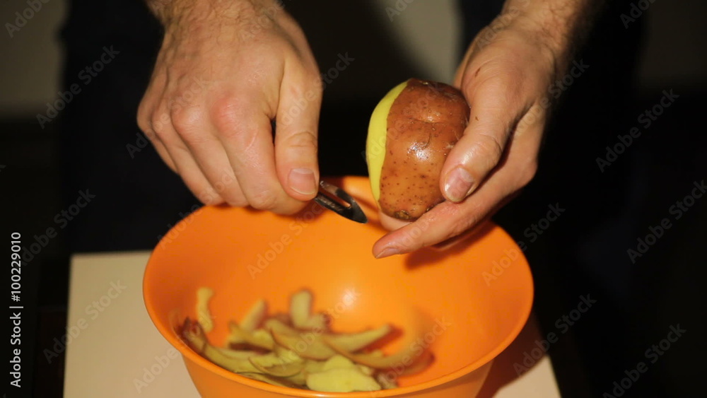 Man peeling potatoes in Kitchen for Prepare food
Man peeling potatoes in Kitchen for Prepare food