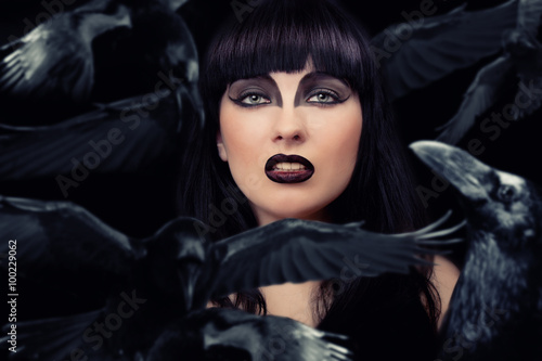 Beautiful dark woman with her crows