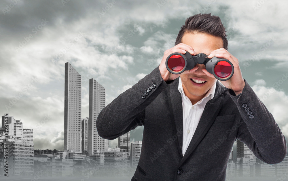 handsome young asian man looking trough a binoculars handsome young asian man looking trough a binoculars