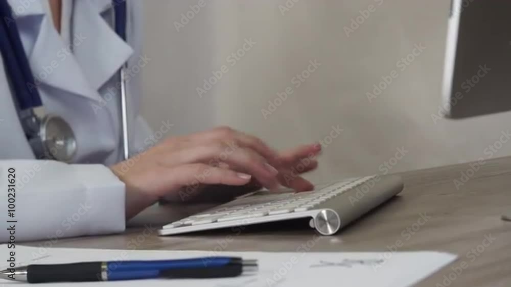 The doctor works at the computer The doctor works at the computer