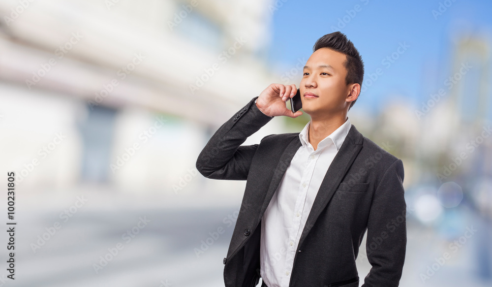 young asian business man talking on mobile young asian business man talking on mobile