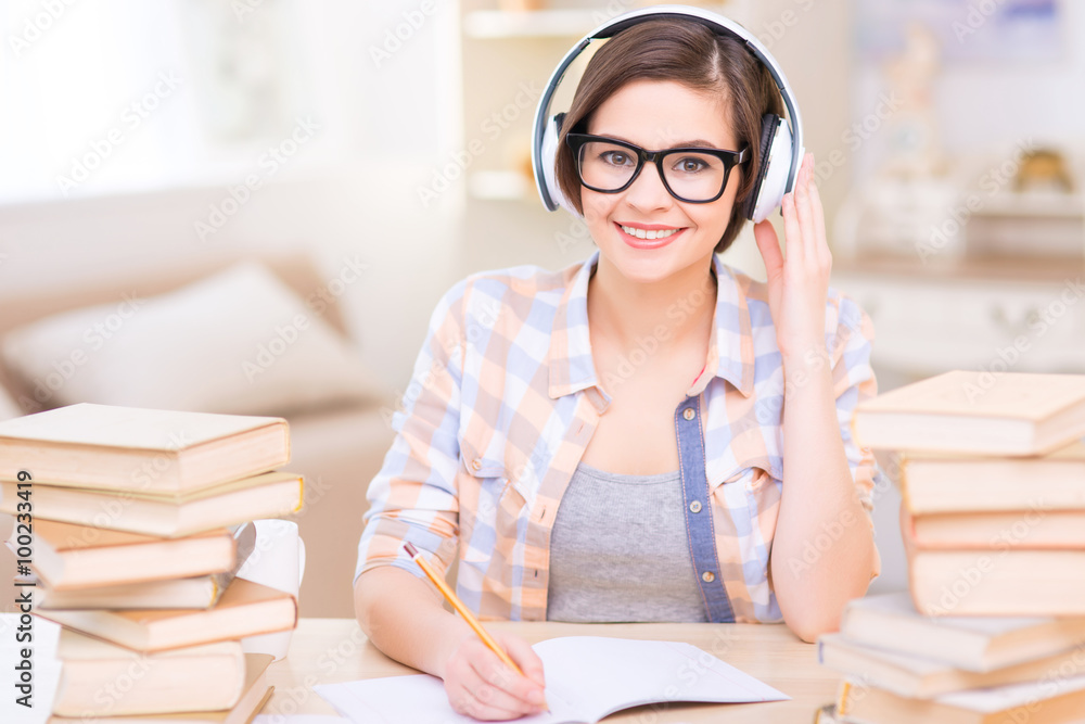 Young female student doing audio exercises. Young female student doing audio exercises.