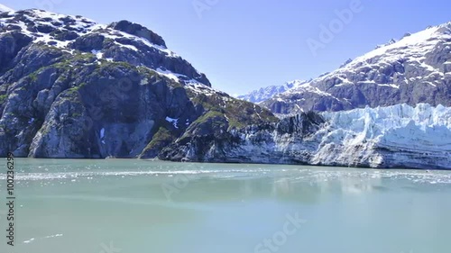 Shot of snow covered mountains and small ice glaciers floating in the water, Alaska photo
