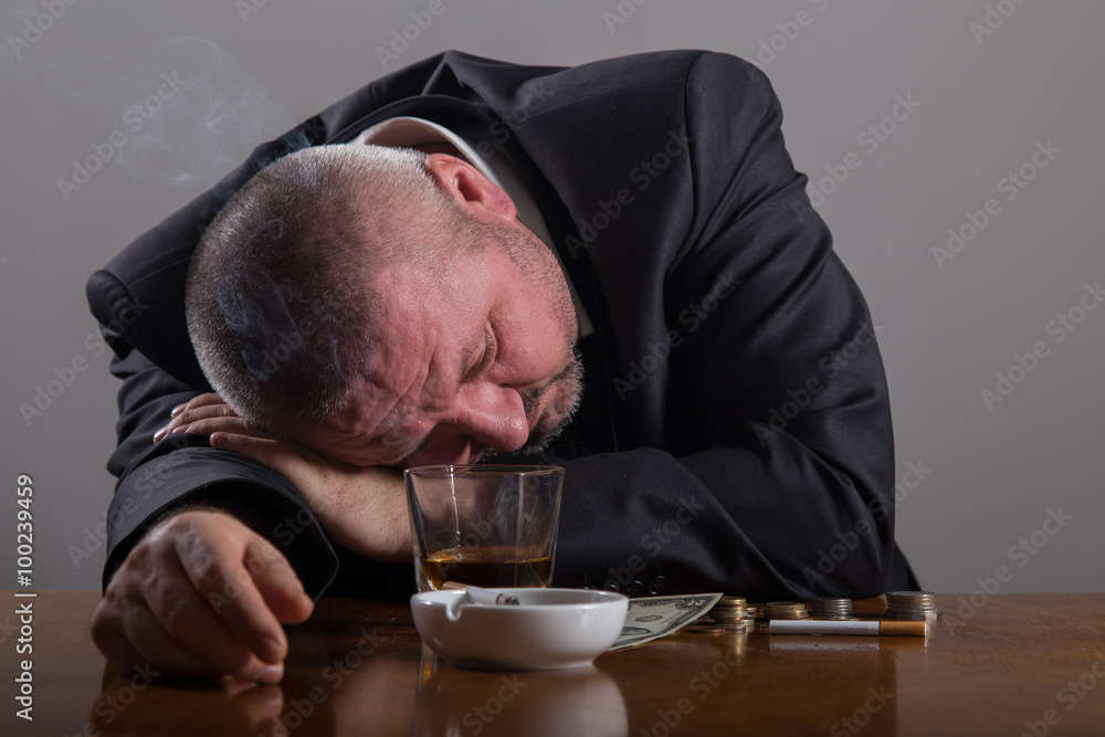 Broke Business man with a glass of whiskey and cigarette Broke Business man with a glass of whiskey and cigarette