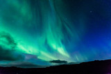 Aurora at night over the land as a background