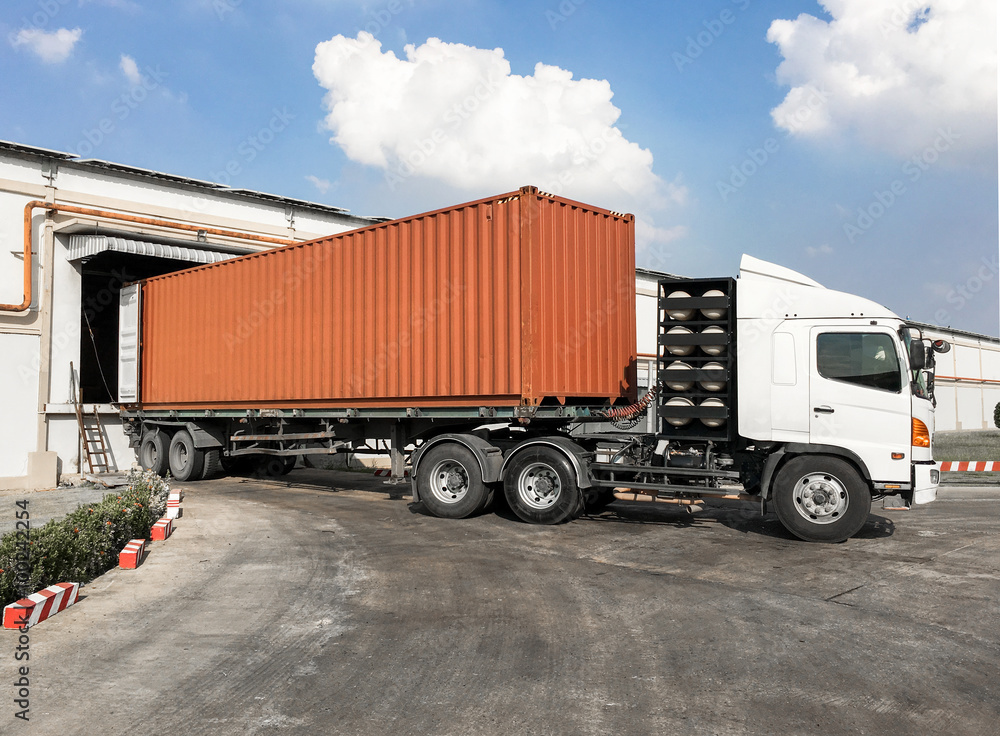 Container truck loading goods at warehouse