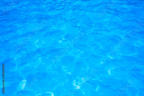 Blue pool water with sun reflections © yotrakbutda