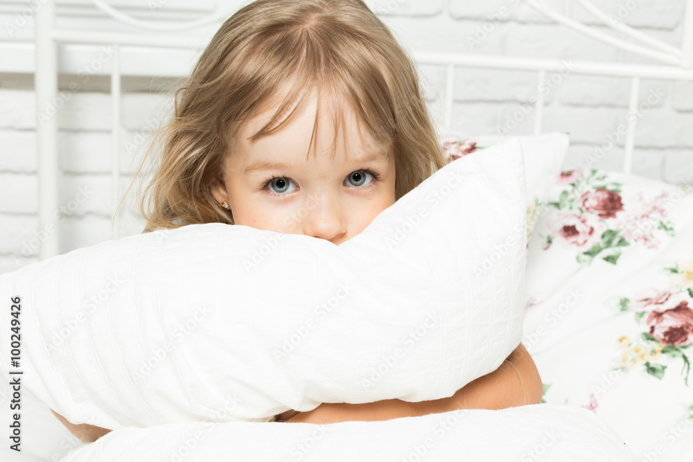 Little blonde girl playing in bed Little blonde girl playing in bed