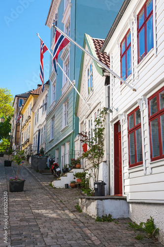 Street with old wooden houses and Norwegian flags in Bergen