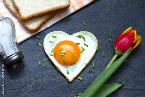 Valentine's Day abstract breakfast with egg heart and tulip
