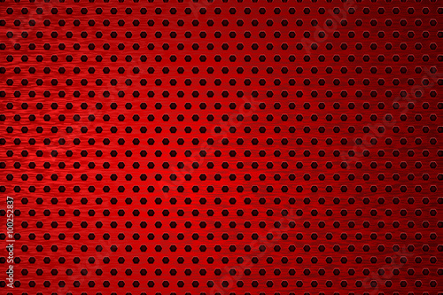Metal background. Red perforated brushed metal. 