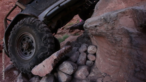 Tire Shot of Jeep Climbing up Rock photo