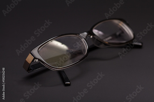 Eyeglasses in a black background