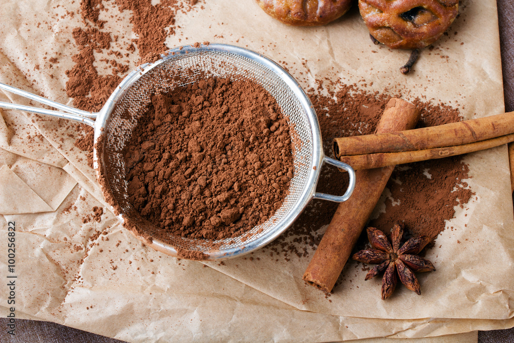 cinnamon, cocoa powder and anise on baking paper cinnamon, cocoa powder and anise on baking paper