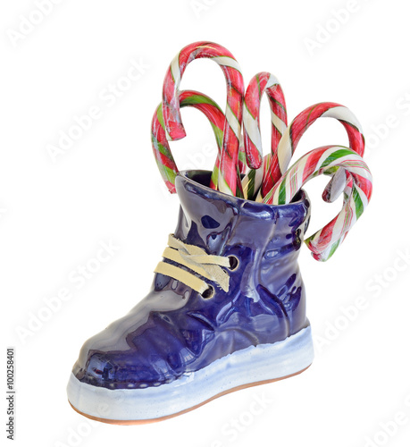 Blue ceramic boots, sneakers, with christmas, holiday candies, sweets, close up, isolated, white background.