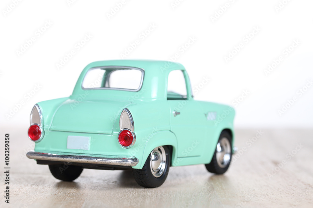 miniature car on wooden floor isolated on white background miniature car on wooden floor isolated on white background