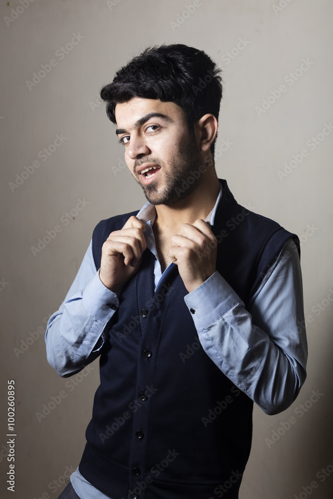Iraqi brunette boy in strange pose inside studio Iraqi brunette boy in strange pose inside studio
