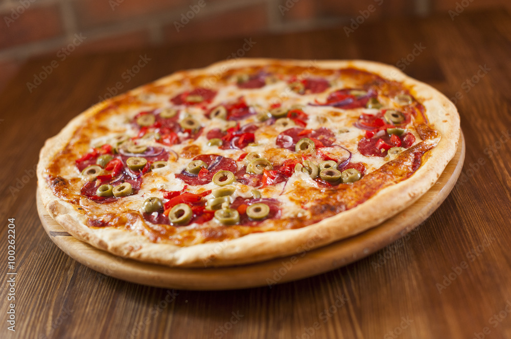 Tasty pizza italiana on the wooden table