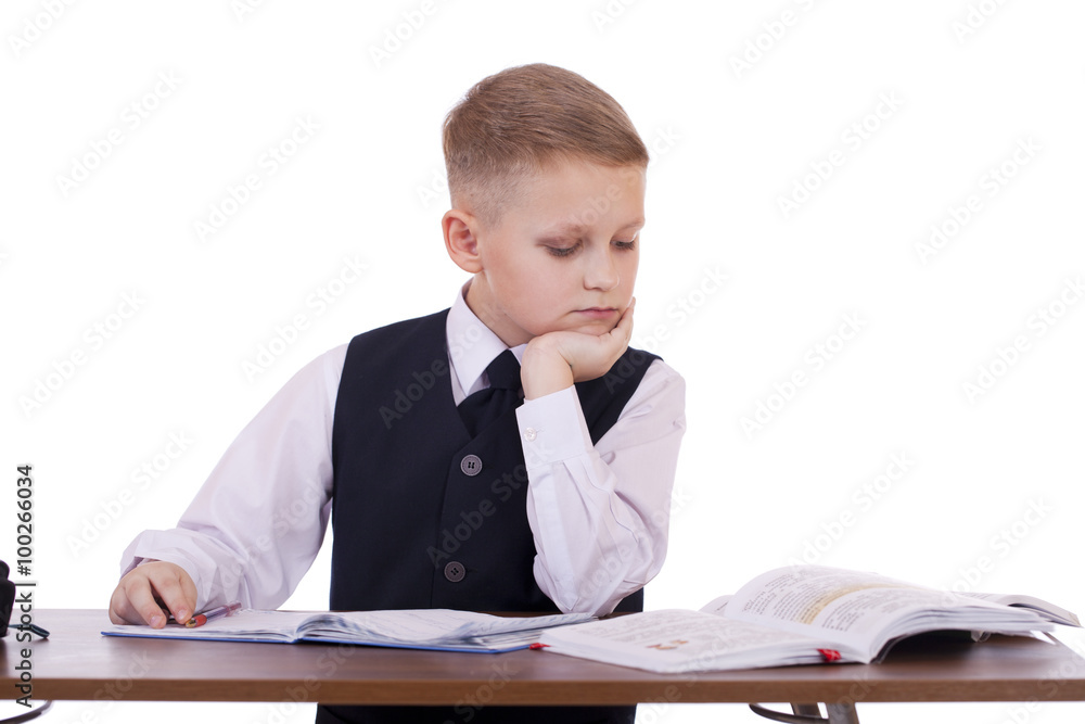 Caucasian school boy at his desk on white background with copy s Caucasian school boy at his desk on white background with copy s