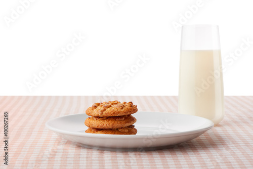Peanut butter cookies on plate and glass of milk