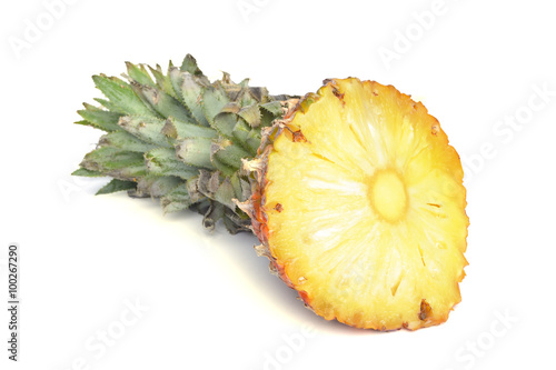 Pineapple and its slices on a white background