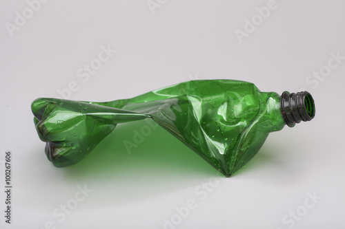 Crushed plastic bottle isolated on gray background