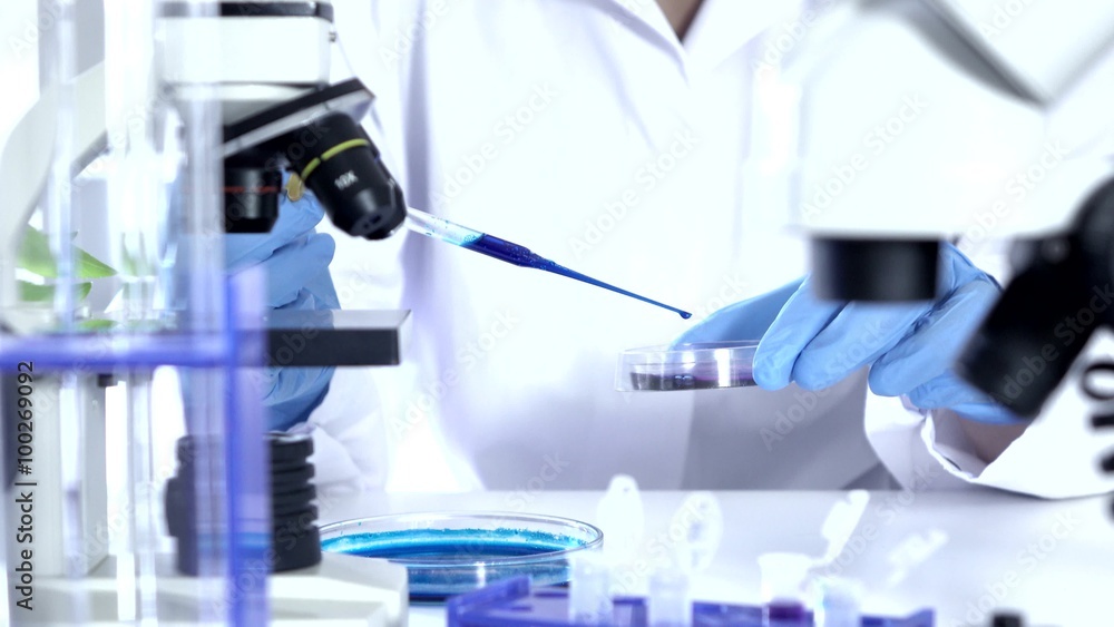Researcher Working in Lab With Microscope.researcher in biochemical lab