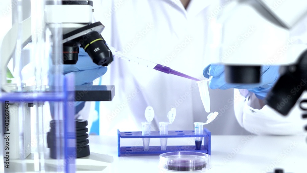 Researcher Working in Lab With Microscope.researcher in biochemical lab Researcher Working in Lab With Microscope.researcher in biochemical lab