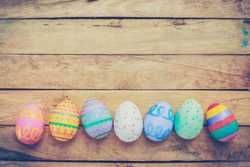 Easter eggs on wooden background with vintage tone.