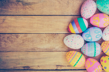 Easter eggs on wooden background with vintage tone.